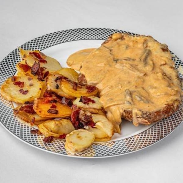 Foodies Restaurant & Catering's fusion dish: breaded meat with creamy sauce and roasted potatoes with bacon.